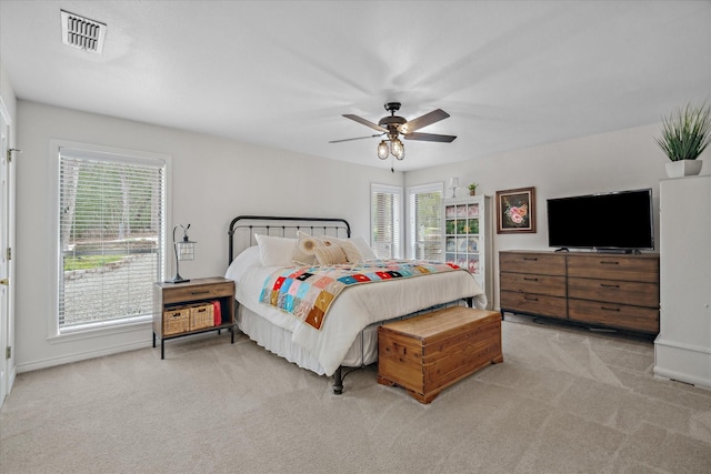 bedroom with ceiling fan, visible vents, and carpet flooring