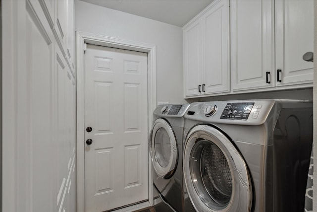 washroom with cabinet space and washing machine and dryer