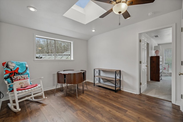 sitting room with vaulted ceiling with skylight, hardwood / wood-style floors, recessed lighting, and baseboards