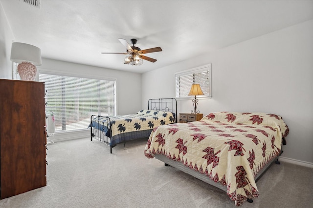 bedroom featuring carpet, visible vents, ceiling fan, and baseboards