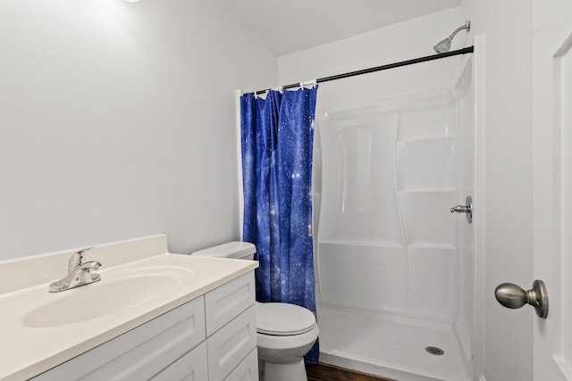 full bath with a stall shower, vanity, and toilet