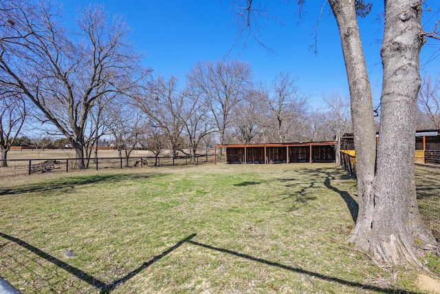 view of yard featuring an outbuilding and fence