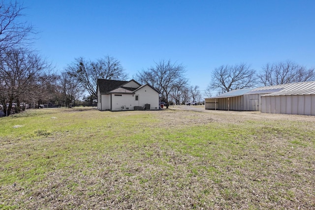 view of yard featuring an outbuilding and an outdoor structure