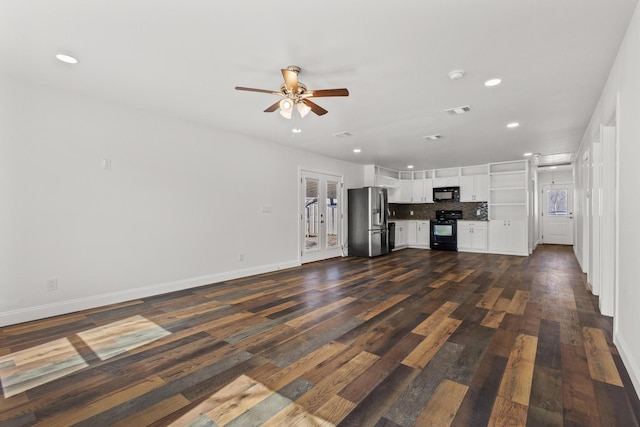 kitchen featuring white cabinetry, visible vents, decorative backsplash, black appliances, and dark wood finished floors