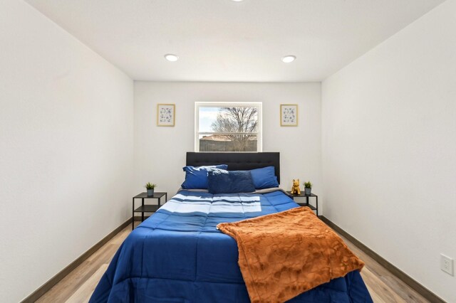 bedroom with recessed lighting, light wood-style flooring, and baseboards