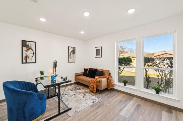 living area featuring recessed lighting, baseboards, and wood finished floors