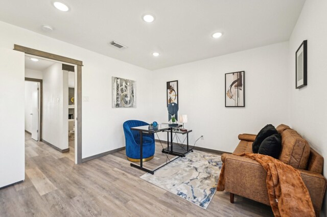 sitting room with light wood-type flooring, visible vents, and recessed lighting