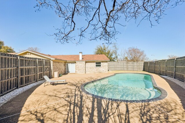 view of swimming pool featuring a fenced in pool, a patio area, and a fenced backyard