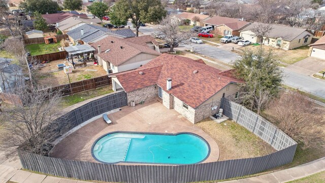 view of swimming pool featuring a patio area, a fenced backyard, a residential view, and a fenced in pool