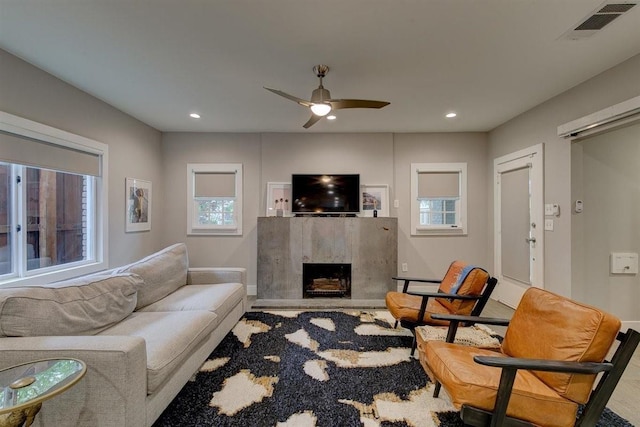 living room featuring recessed lighting, visible vents, a ceiling fan, and a high end fireplace