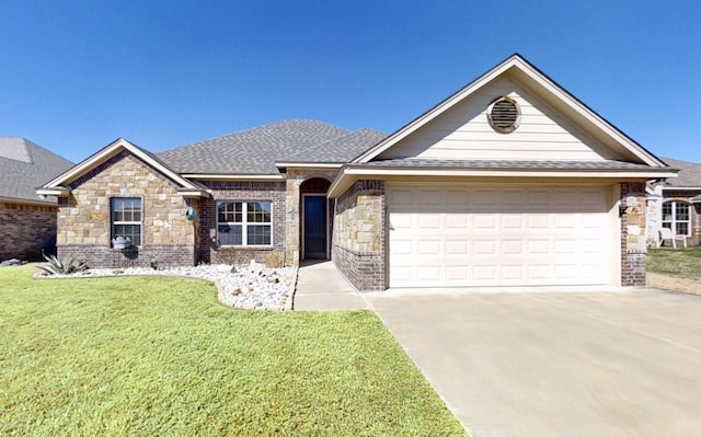 view of front of house with concrete driveway, a front yard, a shingled roof, a garage, and brick siding