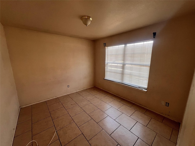 unfurnished room featuring light tile patterned flooring