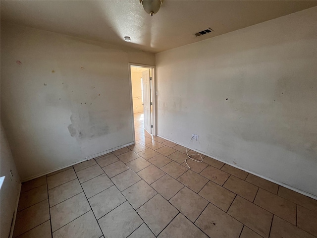 spare room with light tile patterned floors and visible vents