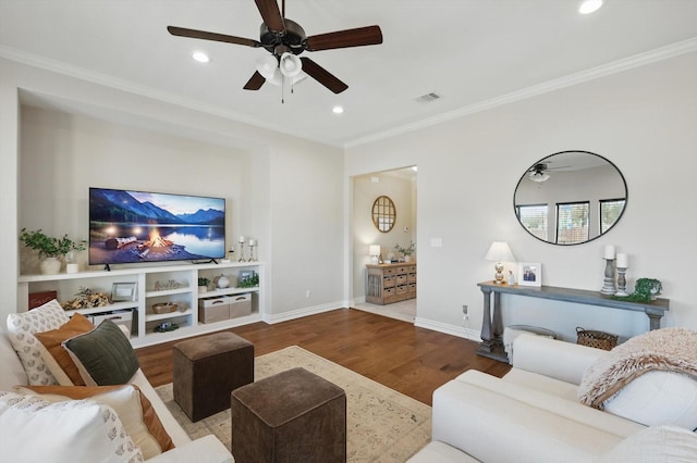 living room featuring ornamental molding, wood finished floors, and recessed lighting