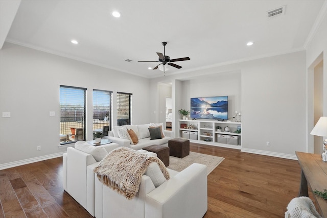 living area with crown molding, recessed lighting, visible vents, dark wood-type flooring, and baseboards