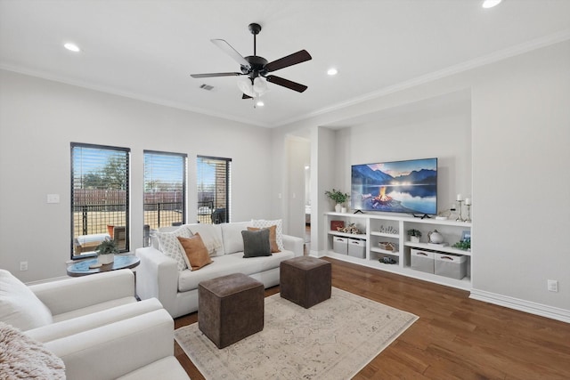 living room with crown molding, visible vents, dark wood-style flooring, and recessed lighting