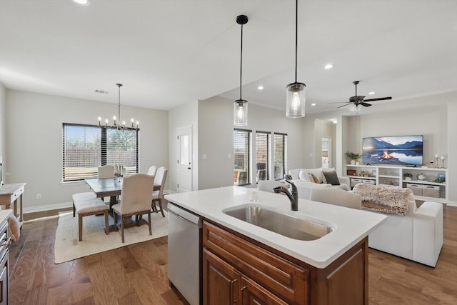 kitchen with dishwasher, a sink, a wealth of natural light, and dark wood-style floors