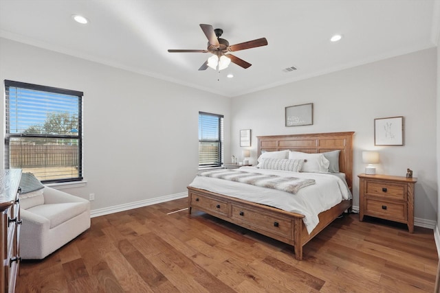 bedroom featuring ornamental molding, recessed lighting, wood finished floors, and baseboards