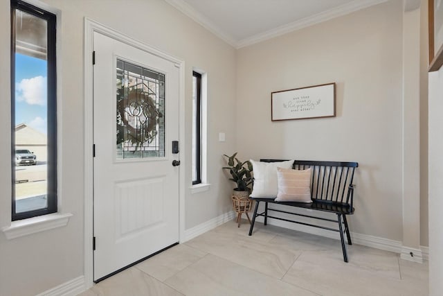 foyer entrance featuring baseboards and crown molding