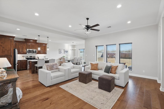 living room with recessed lighting, wood finished floors, a ceiling fan, baseboards, and visible vents