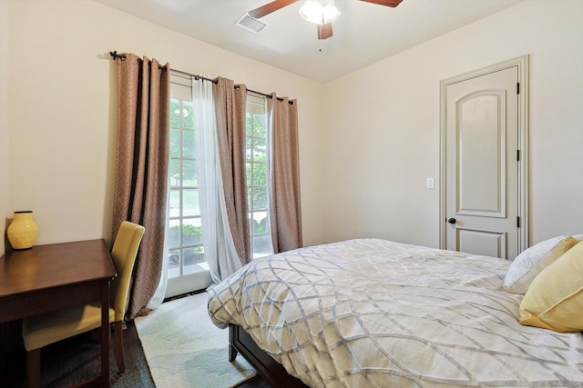 carpeted bedroom featuring a ceiling fan and visible vents