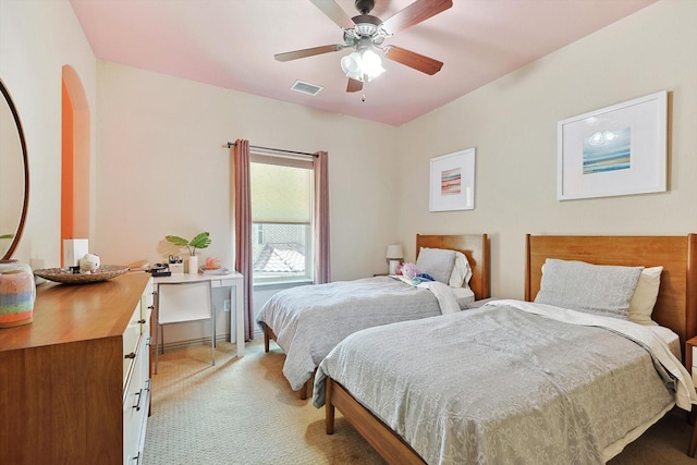 bedroom featuring ceiling fan, visible vents, and light colored carpet