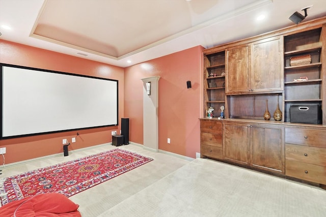 cinema room with a tray ceiling, recessed lighting, visible vents, light carpet, and baseboards