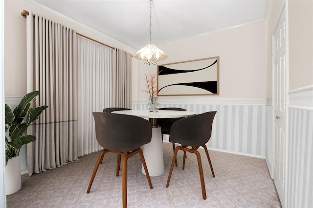 dining space with a chandelier and light colored carpet