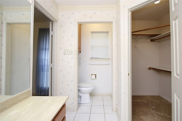 bathroom featuring wallpapered walls, baseboards, toilet, tile patterned flooring, and vanity