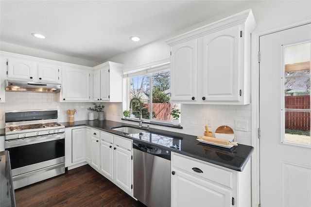 kitchen with appliances with stainless steel finishes, a sink, white cabinets, and under cabinet range hood