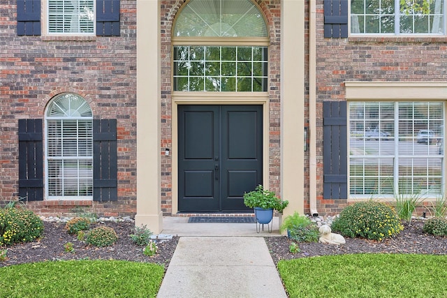 property entrance with brick siding