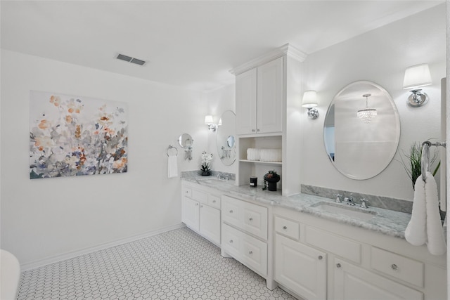 full bath with visible vents, a sink, baseboards, and double vanity