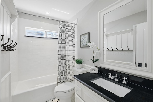 bathroom with toilet, shower / bath combination with curtain, and vanity