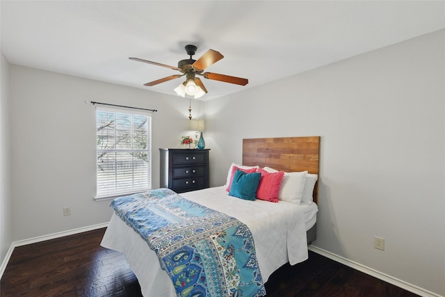 bedroom featuring ceiling fan, wood-type flooring, and baseboards