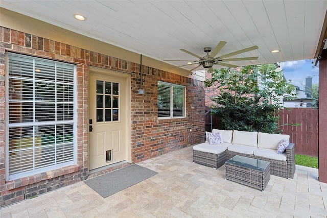 view of patio / terrace with ceiling fan, an outdoor living space, and fence