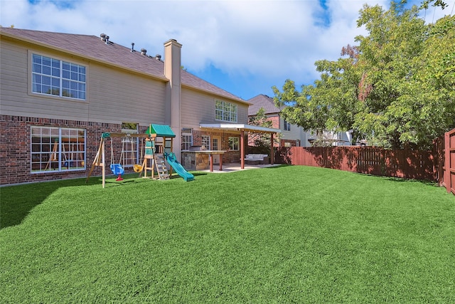 view of yard with a patio, a playground, and a fenced backyard