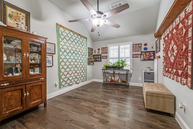 interior space featuring vaulted ceiling, ceiling fan, dark wood finished floors, and visible vents