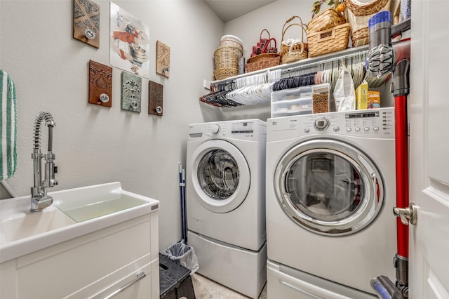 laundry area with washer and dryer, laundry area, and a sink