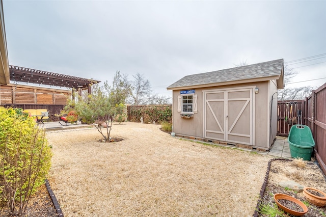 view of shed featuring a fenced backyard and a pergola