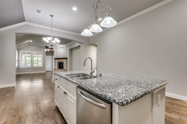 9804 Bitterroot Dr, Little Elm, TX 75068 - kitchen with dishwasher, a chandelier, a fireplace, lofted ceiling, and stone counters