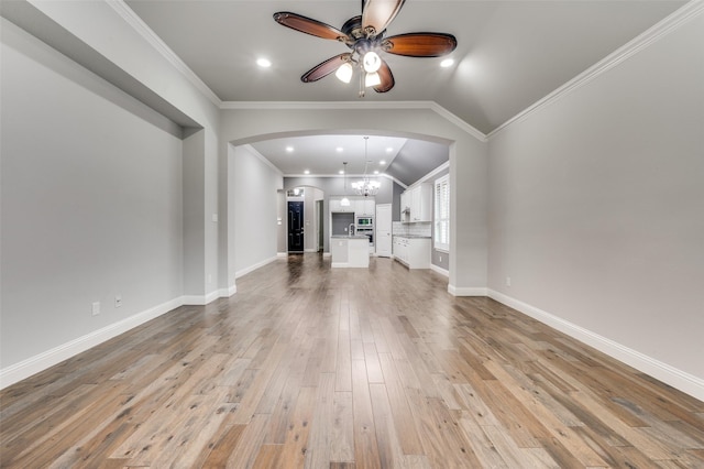 9804 Bitterroot Dr, Little Elm, TX 75068 - unfurnished living room with arched walkways, a ceiling fan, light wood-type flooring, recessed lighting, and vaulted ceiling
