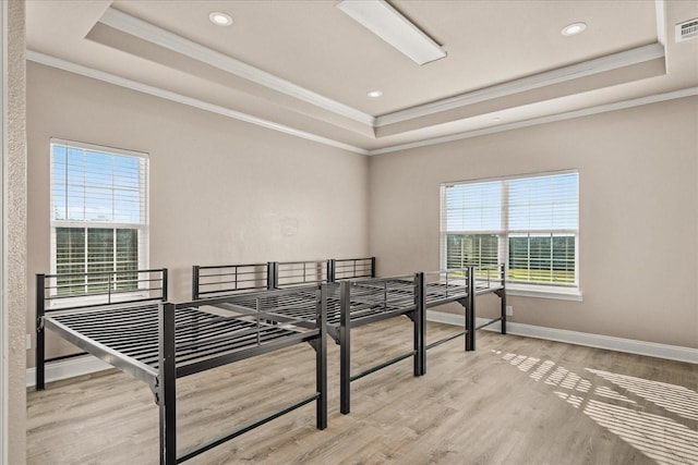 empty room with a raised ceiling and a healthy amount of sunlight