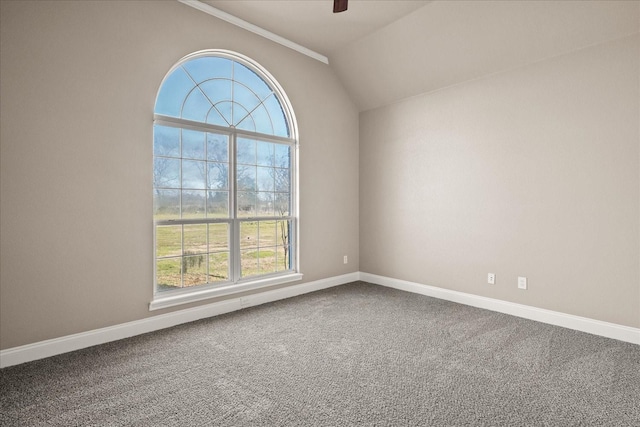 unfurnished room with carpet floors, lofted ceiling, baseboards, and a ceiling fan