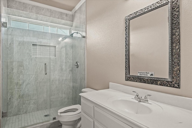 full bath featuring vanity, ornamental molding, a shower stall, and toilet