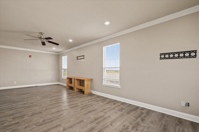 unfurnished room with plenty of natural light, baseboards, and wood finished floors