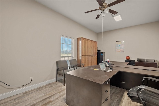 office space with a ceiling fan, light wood-style flooring, and baseboards