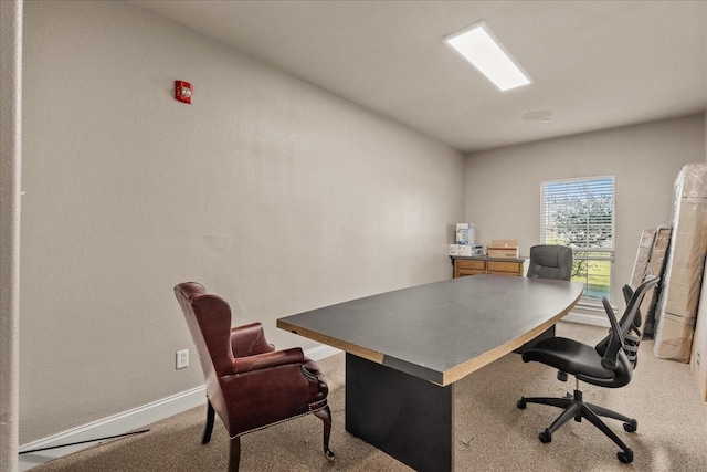 carpeted office featuring baseboards