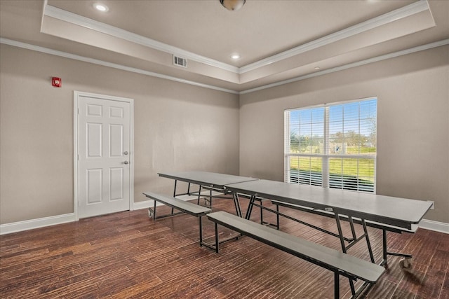 game room with hardwood / wood-style floors, a tray ceiling, visible vents, and baseboards