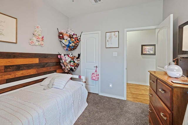 bedroom with carpet floors, visible vents, and baseboards