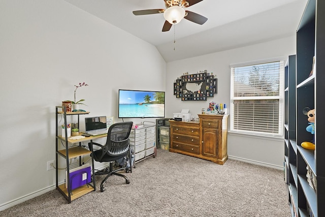 carpeted office with vaulted ceiling, a ceiling fan, and baseboards